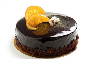 Chocolate flavoured cake with decorative orange slices